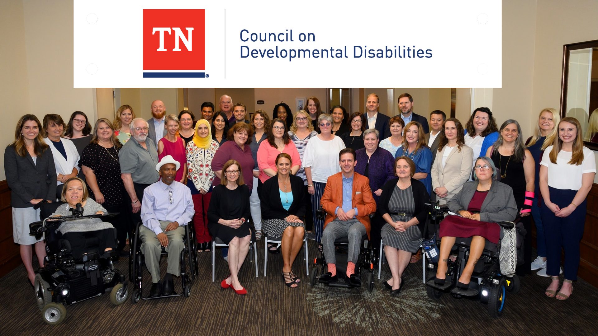 Image of a group of people with a white banner on top of image with the branded graphic of TN Council on Developmental Disabilities. 