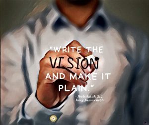 Blurry background of a person in a gray dress shirt holding a dark marker in his hand and writing in a transparent whiteboard. Text on transparent whiteboard is from the King James Bible and reads “WRITE THE VISION AND MAKE IT PLAIN”. Pathfinder's branded graphic is under the image.