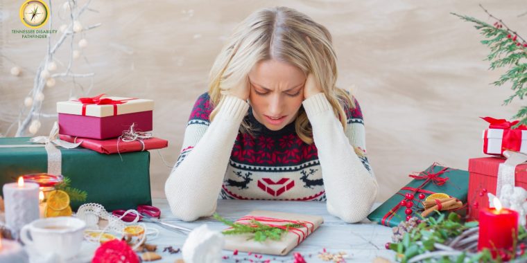 Person wearing a patterned holiday sweater sits at a table covered with wrapped gifts, candles, and festive decorations. The Tennessee Disability Pathfinder logo appears in the top left corner, and the scene suggests holiday stress or overwhelm.