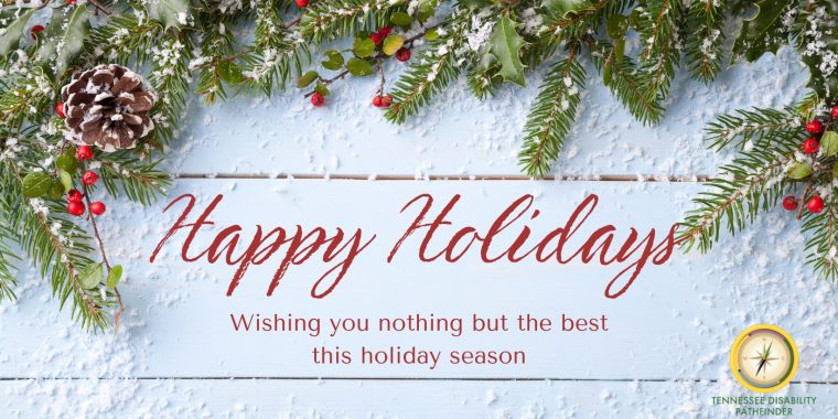 Festive holiday graphic featuring a light blue wooden background with snow-dusted evergreen branches, red berries, and a pinecone along the top edge. Center text reads “Happy Holidays” with a message: “Wishing you nothing but the best this holiday season.” The Tennessee Disability Pathfinder logo is in the bottom right corner.