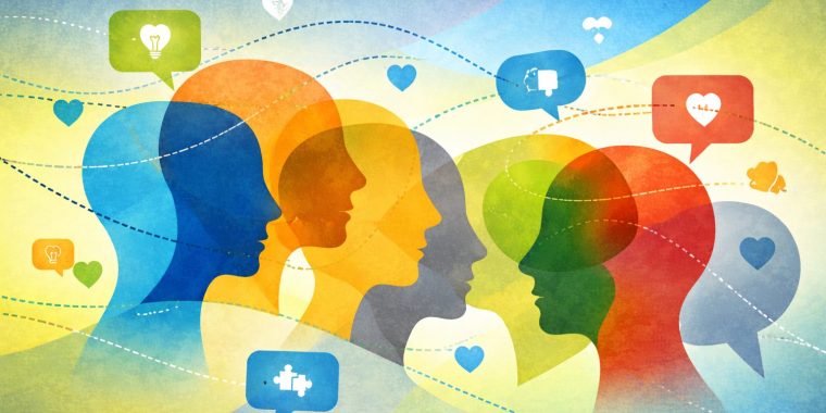 A wide horizontal illustration shows overlapping colorful profiles of people facing different directions, representing diverse perspectives and communication styles. Bright silhouettes in blue, orange, green, yellow, red, and gray are layered across the image, connected by dotted lines and floating icons such as hearts, light bulbs, and conversation bubbles. The flowing background transitions from blue to green, creating a sense of movement and dialogue. The image symbolizes varied ways of thinking, communicating, and understanding, reflecting respectful conversations about autistic traits and recognizing both strengths and support needs.